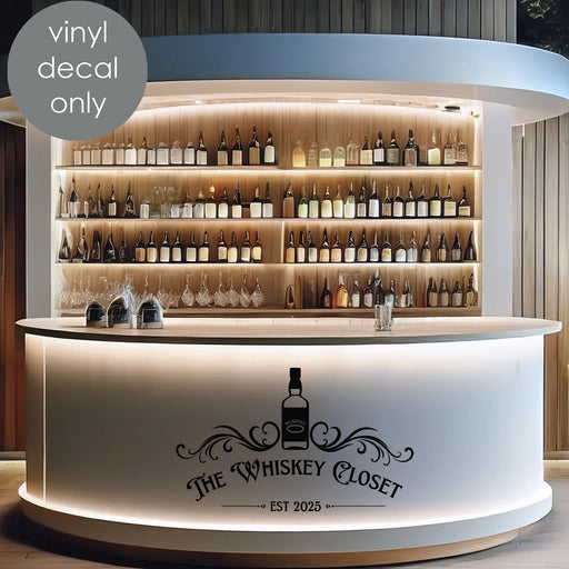 Custom vinyl decal “The Whiskey Closet EST 2025” with whiskey bottle design on modern bar counter