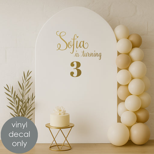 Custom birthday vinyl decal “Sofia is turning 3” in gold letters for kids’ party backdrop decoration