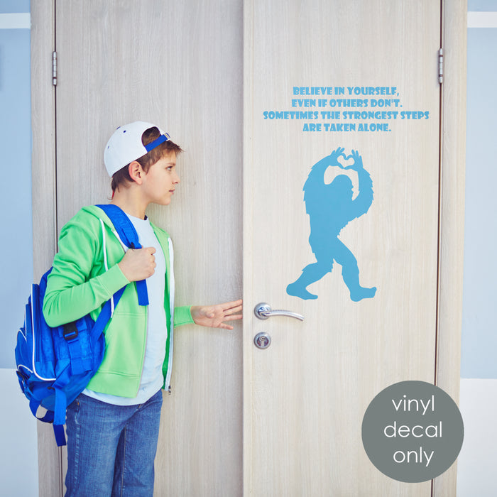Motivational Bigfoot vinyl decal with positive quote on a door, ideal for kids’ room or classroom decoration.