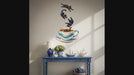 Slow zoom toward four playful black cats tumbling toward a blue coffee cup