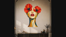 Slow zoom toward a woman's face framed by vivid red poppies and geometric warm colors