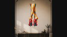 Slow zoom toward a pair of vivid red high heels beneath long, colorful legs