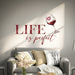 Wine quote wall decal displayed above a sofa.