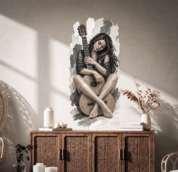 Seated woman playing guitar wall decal in a room
