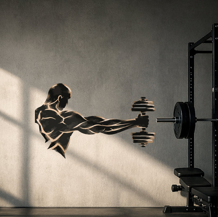 Dumbbell athlete wall decal on a dark gym wall